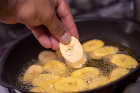 Banana fried in a frying pan. The process of cooking bananas.の写真素材