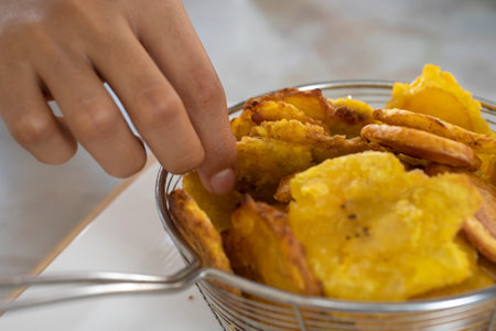 Crispy fried potatoes in a metal bowl on the table.の写真素材