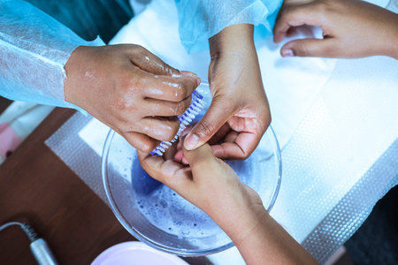 Manicure and pedicure process in beauty salon. Close-up of manicurist hands making pedicure.