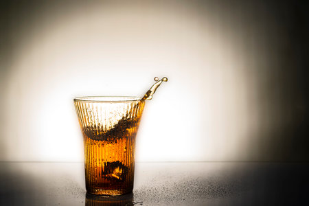 Cocktail in a glass with drops of water on a white background