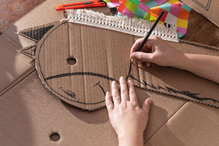 Toy being made by hand at home. Horse made of cardboard. Craftsmanship.の写真素材
