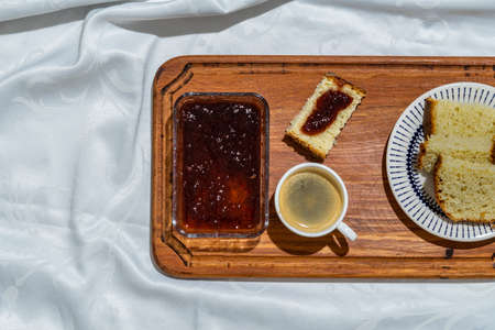 Delicious breakfast table with bread, strawberry jam, and coffee on the table. Sweet dessert.の写真素材