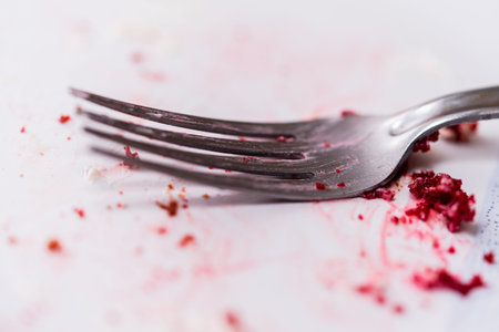 Fork with remnants of a delicious cake. Close-up image.