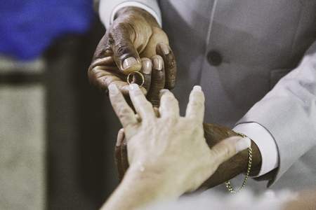 Religious moment of the exchange of alliances during the marriage in the catholic church.の写真素材