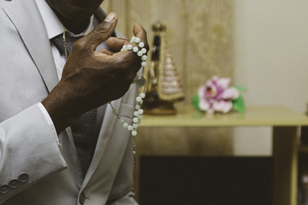 Black man with third in hands. Praying before the wedding.の写真素材