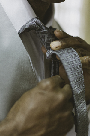 Black man fixing tie for wedding.の写真素材