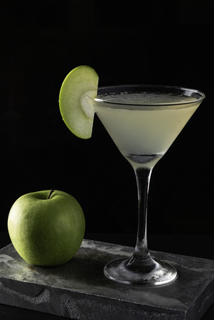 Apple Martini cocktail is on the bar. Space for text. Photo for the menu.の写真素材