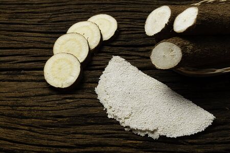 Beiju of tapioca, cassava-based dish typical of the northeastern region of Brazil, now consumed in the whole country on old wooden background.の写真素材