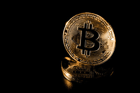 Various physical metal coins scattered over black background. Cryptocurrency concepts.
