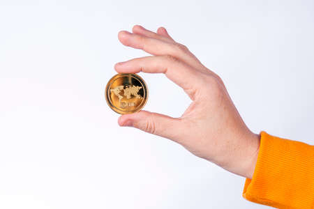 Woman holding Shiba Inu (SHIB) physical coin, Cryptocurrency concepts on white background..の写真素材