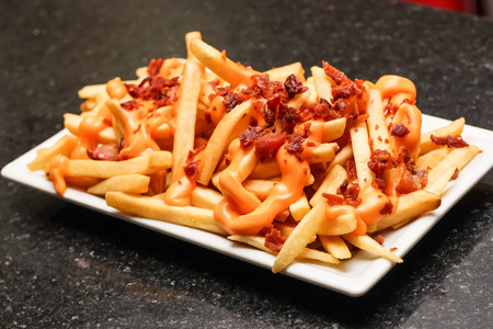 portion of fries with baconの写真素材