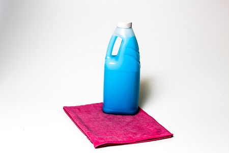 Cleaning products blue, green, purple and pink colored bottles and colored clothsの写真素材