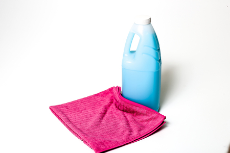 Cleaning products blue, green, purple and pink colored bottles and colored clothsの写真素材