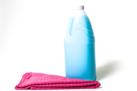 Cleaning products blue, green, purple and pink colored bottles and colored clothsの写真素材