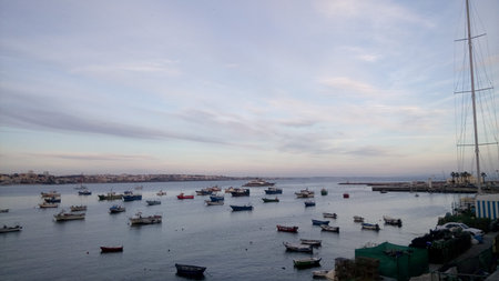 CASCAIS, PORTUGAL - APRIL 14, 2017: Cascais dock with boats and sailboat on Holy Week break at sunsetのeditorial素材
