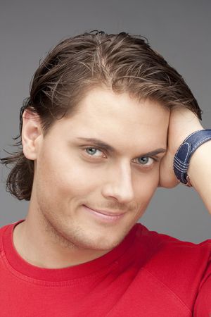 beautiful man in red on a grey background. Ñlose upの写真素材