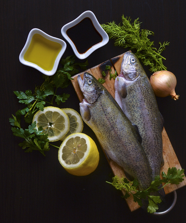 fresh fish rainbow trout with lemon and onionの写真素材