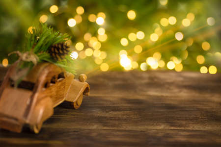 Car with a Christmas tree on the background of bright Christmas bokeh lightsの写真素材