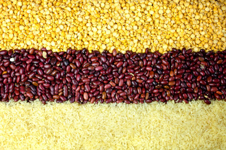 Crushed dry peas, red beans, rice background. Top view