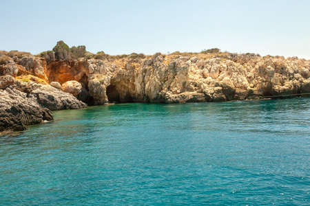 Turkish diving near the rocks. Azure lagoon and stone rocks. Turkish beach in Kemer.の写真素材