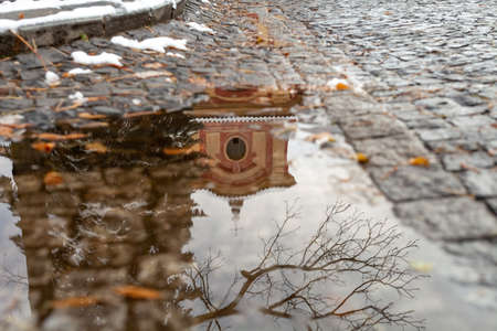 Reflection on water puddle of colorful old houses in historic center of Prahaの写真素材