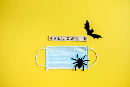 protective mask on a yellow background with the inscription Halloween. Halloween symbol 2020の写真素材