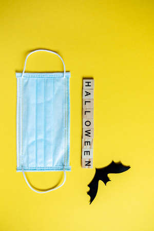Top view of halloween lettering with wooden cubes on yellow backgroundの写真素材