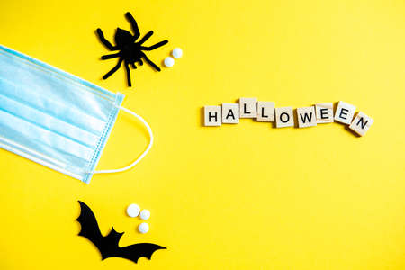 Top view of halloween lettering with wooden cubes on yellow backgroundの写真素材