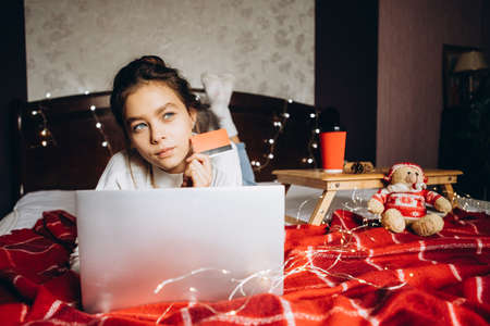 Young woman enjoying shopping online for Christmas. christmas shopping and salesの写真素材