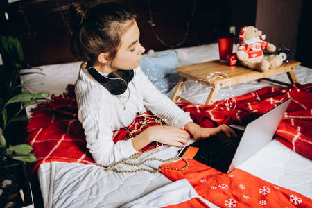 Young woman enjoying shopping online for Christmas.の写真素材