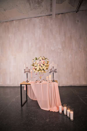 Decorating a wedding table with candles and expensive dishesの写真素材