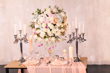 Decorating a wedding table with candles and expensive dishes. Close-upの写真素材