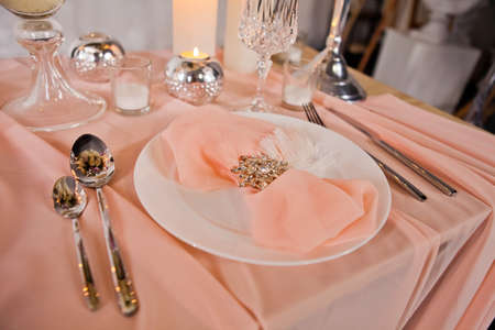 Wedding table setting with tablecloths, expensive dishes and decorations.の写真素材