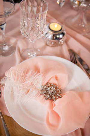 Wedding table setting with tablecloths, dishes and decorations.の写真素材