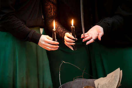 Three vintage witches perform magic ritual. Close-upの写真素材
