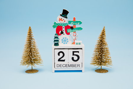 Christmas decorations and perpetual calendar on blue backgroundの写真素材
