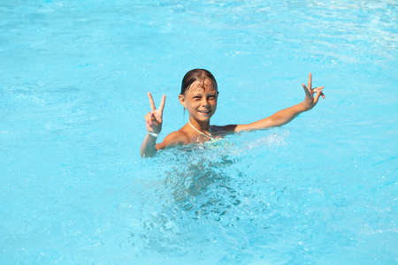 Happy Child Swimming In The Pool. Summer holiday idyllic.の写真素材