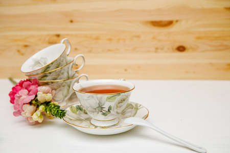 Porcelain cup of herbal tea and flowers on light background. Selective focus, soft focus. copy spaceの写真素材