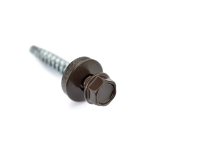 Metal fasteners. Tapping screw for mounting metal roof on a white background, close-up. Selective focus.の写真素材