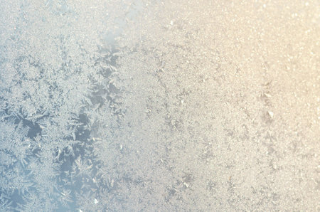 Light blue frosty patterns on the glass as a background, selective focus.の写真素材