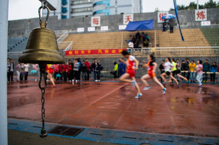 Bell with background of athletes running in the stadiumのeditorial素材