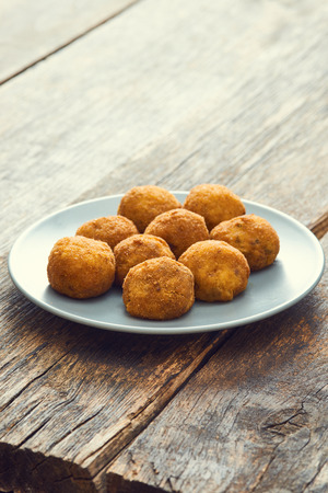 Arancini sicilian street food - rice balls stuffed with meat cookedの写真素材