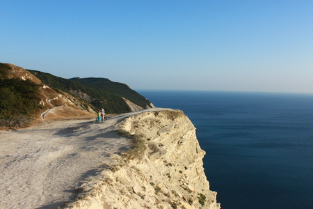 Cyclists on the rocky seashoreの写真素材