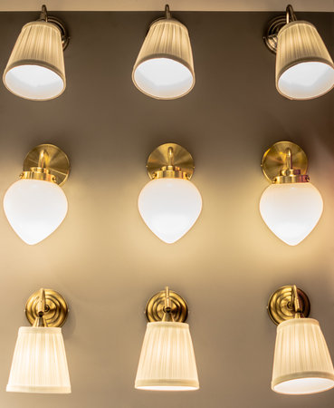 Wall lamps, three rows of three identical lamps, in warm, light colors.の写真素材