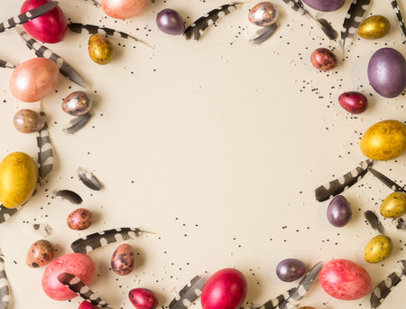 Easter holiday. Beautiful, multi-colored, mother-of-pearl eggs lie on a uniform beige background....