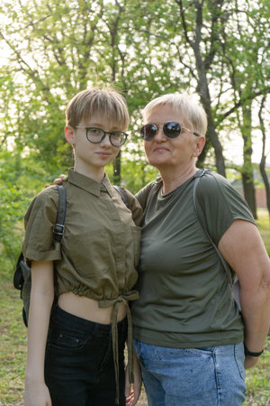 An elderly fashionable modern creative grandmother and her fashionable teenager granddaughter are...
