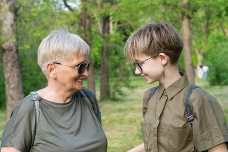 An elderly fashionable modern creative grandmother and her fashionable teenager granddaughter are...