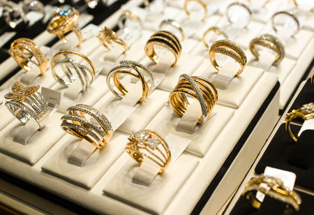 Golden rings with diamonds and other gemstones jewelry for women in the gold marketの写真素材