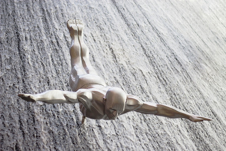 DUBAI, UAE - OCTOBER 16, 2017: Single diver at Famous Waterfall in Dubai Mall. Vertical photo. Selective focus.のeditorial素材