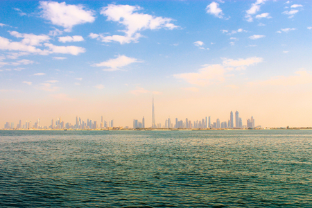 The center of Dubai is in a haze, foggy. View from the sea. Toned photoのeditorial素材